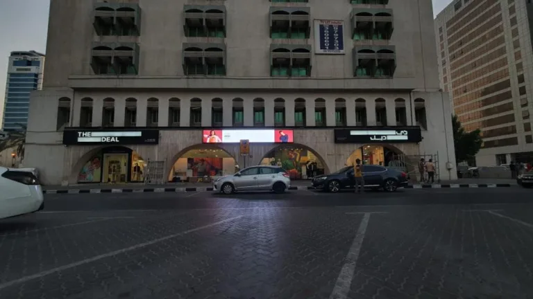 an Outdoor LED screen mounted on a building showcasing vibrant visuals