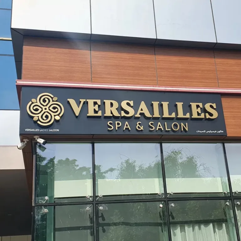 A building featuring a 3D signage that reads "Versaille's Spa and Salon," inviting visitors