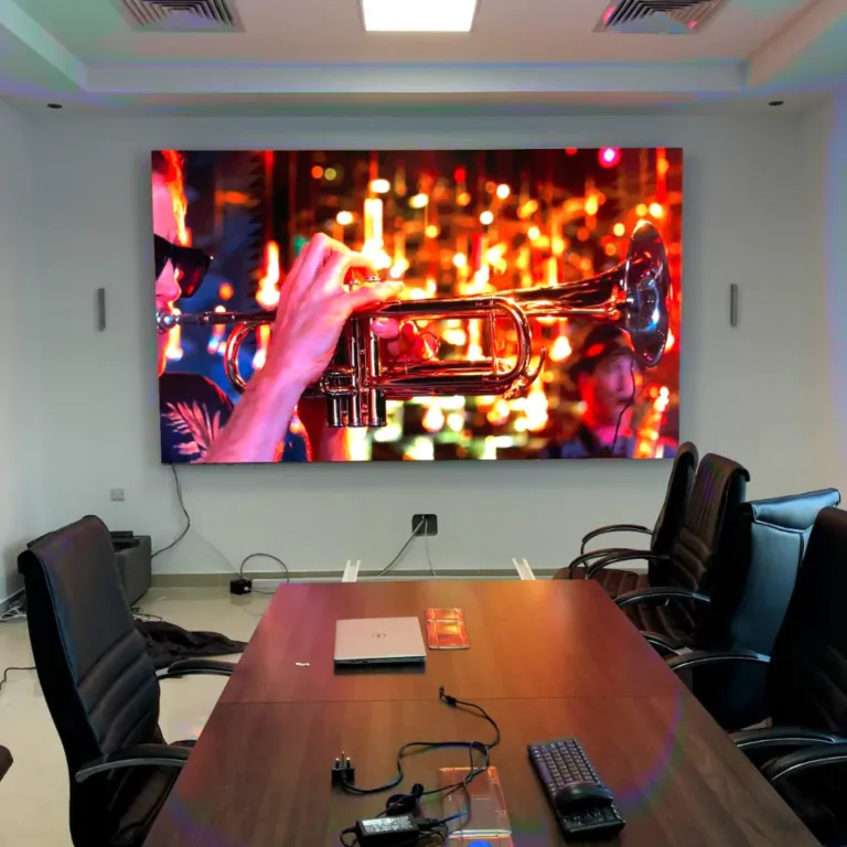 A LED display mounted on the wall of a conference room, ready for presentations.