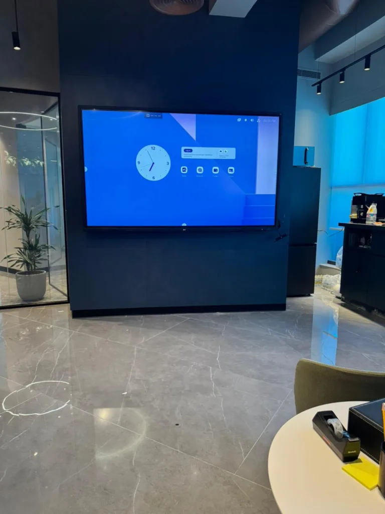 an interactive LCD screen displayed in a well-furnished room, enhancing the modern interior design.