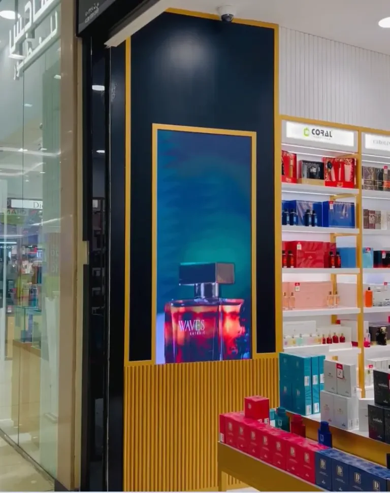 A perfume store highlighted by a front indoor LED display.