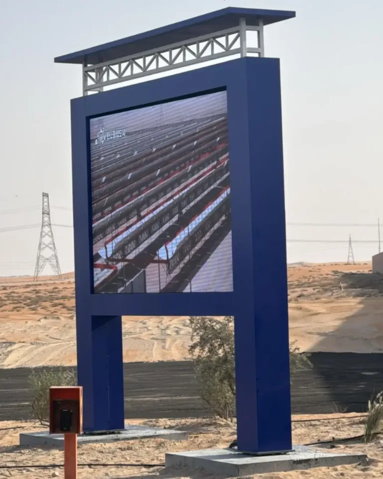An Outdoor LED display screen or Outdoor screen LED stands in the desert, showing vibrant visuals.