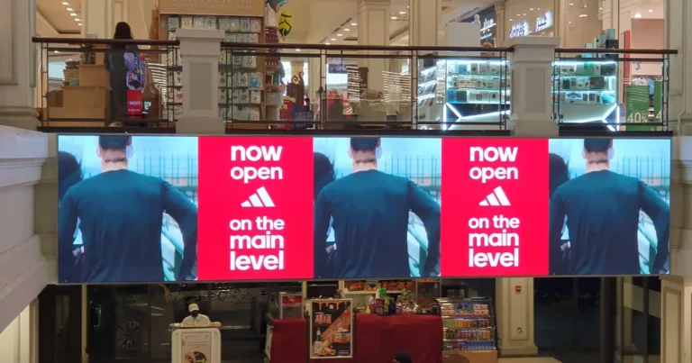 A large screen of dubai led displays the ad of a shop opening
