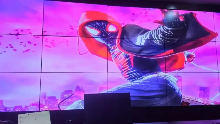 An LED screen advertising board showcases a dynamic Spider-Man character, full of color and energy.
