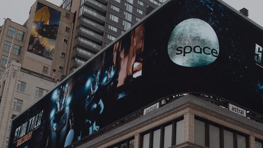Digital screen displays A digital screen featuring visuals of rockets and promoting upcoming space missions.