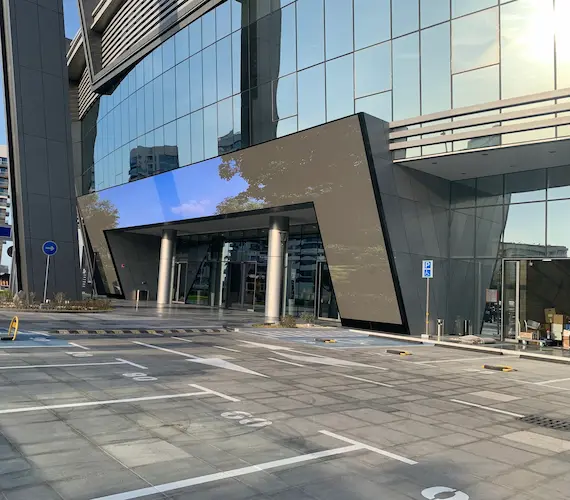 An outdoor LED screens displays content in front of a building.