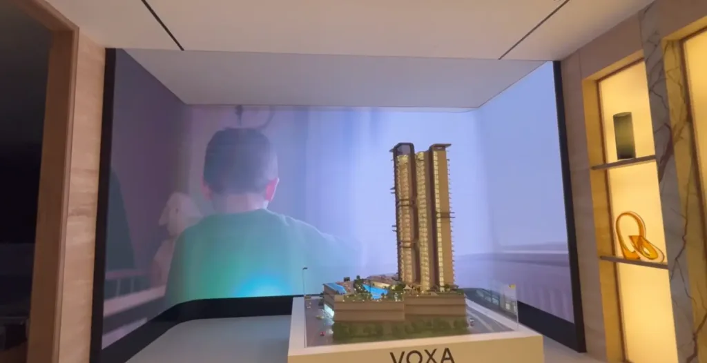building model displayed in a room featuring a digital display signage or digital signage display.
