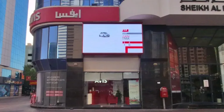 outdoor LED screens mounted on the side of a building, displaying vibrant visuals