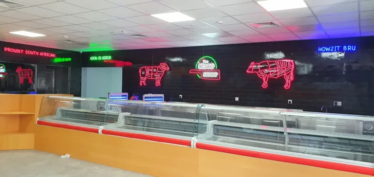 Eye-catching neon sign with a cow design and brand name, adding charm to the restaurant's decor.