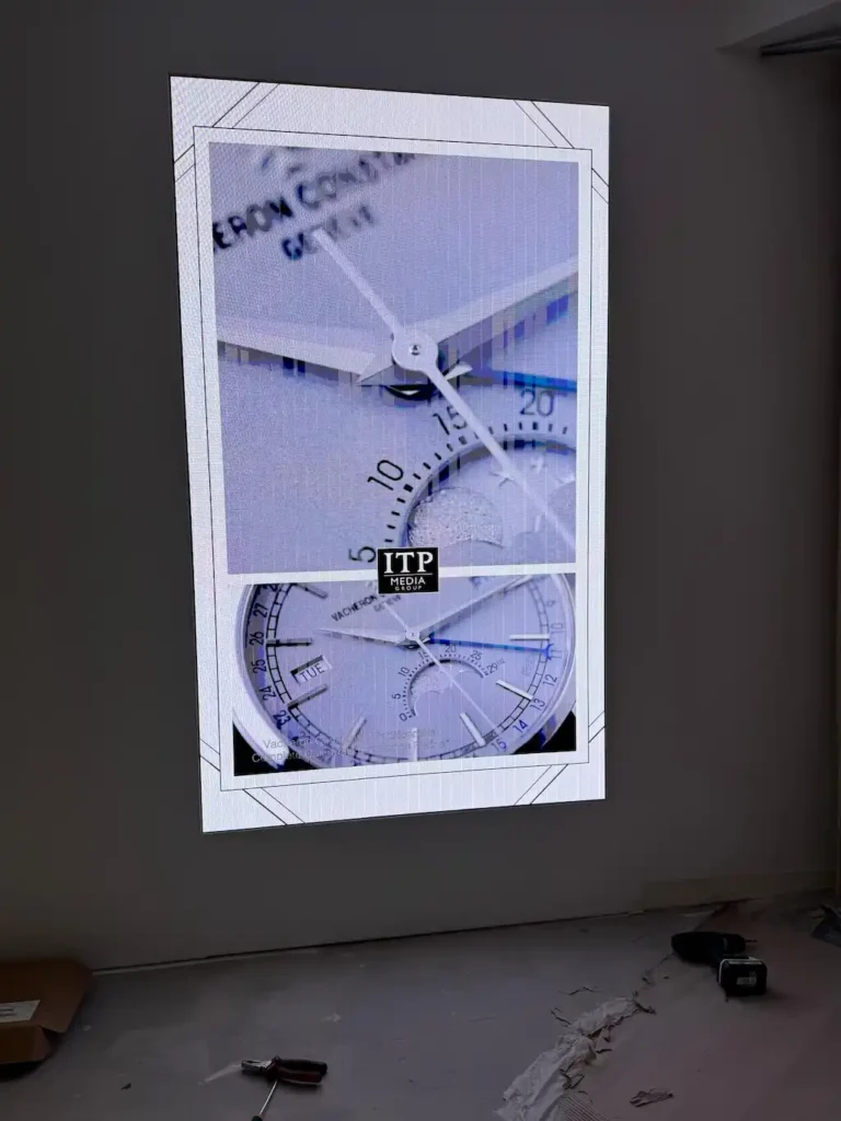a large indoor LED screen showcasing a watch.