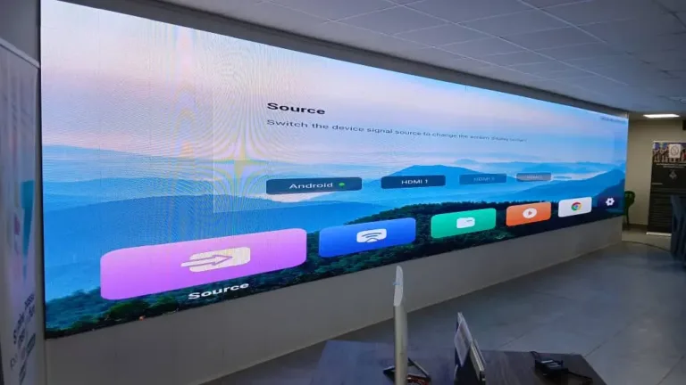 A large indoor LED screen displaying vibrant visuals in a modern room setting.