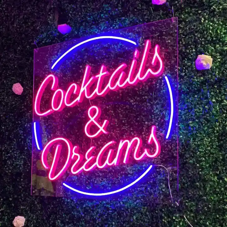 Neon signage written as cocktails and dreams.