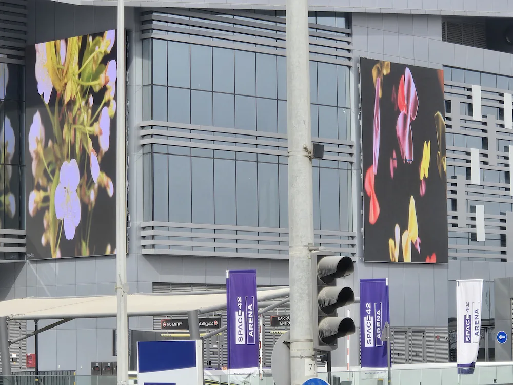 A building with many windows, showcasing many bright LED Screen p6 outdoor.