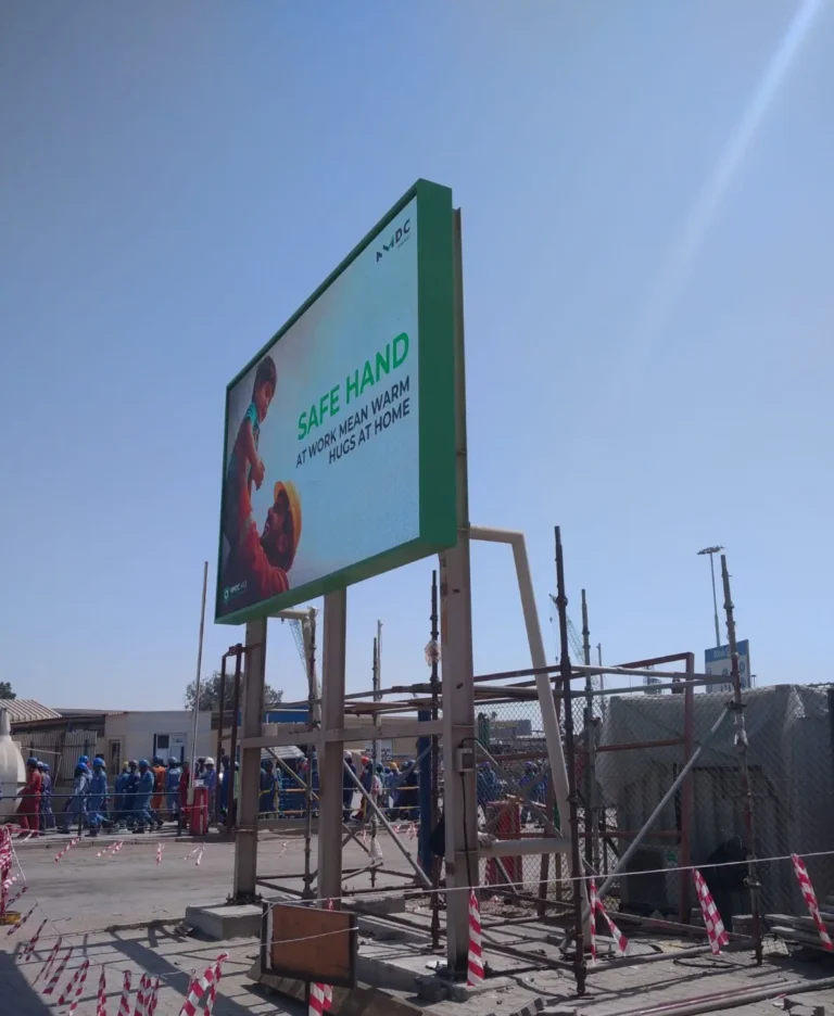 Outdoor LED billboard featuring a worker alongside a safety quote promoting workplace safety.