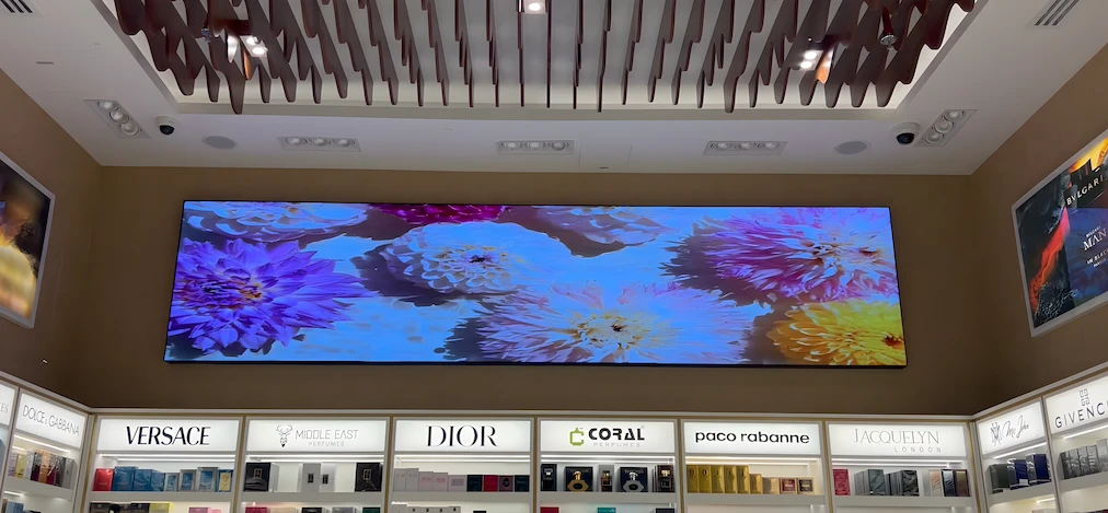 Large store LED screen showing a vibrant flower arrangement.