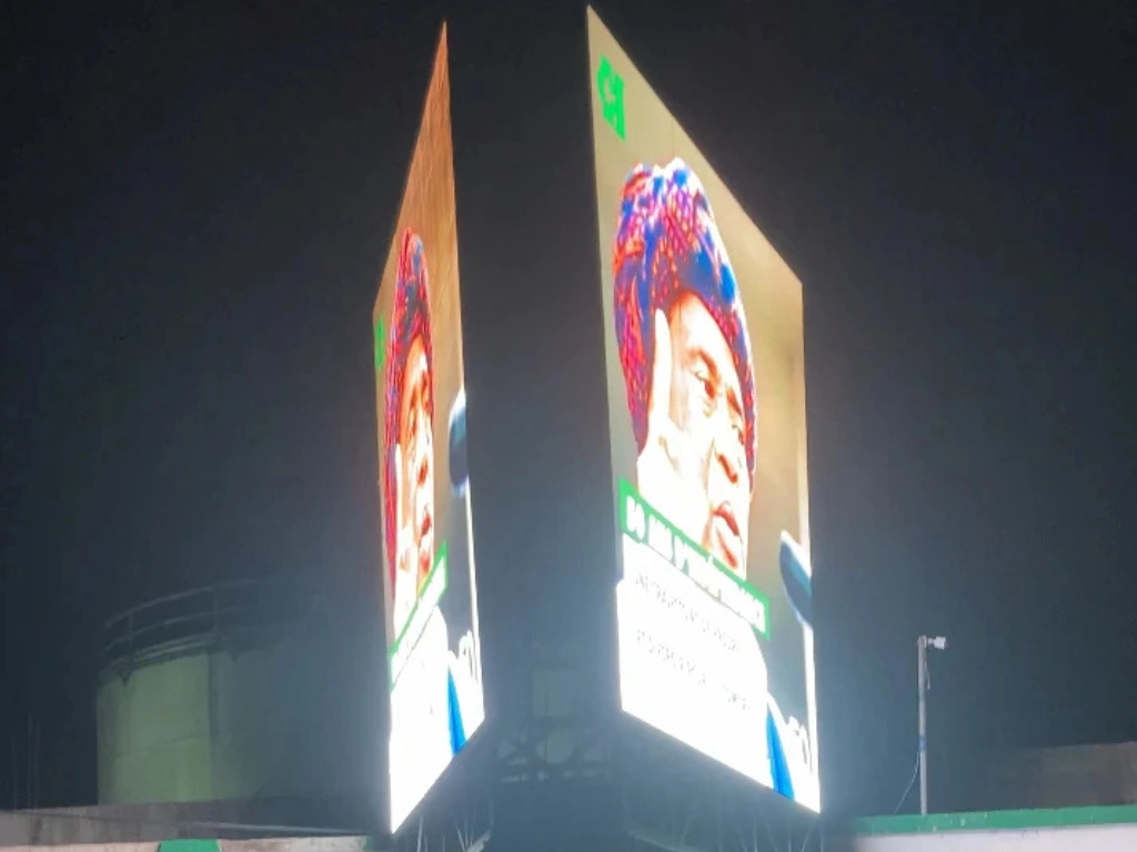 A large outdoor LED display screen featuring a vibrant image.