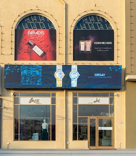 Large commercial building with shop led display on the front.