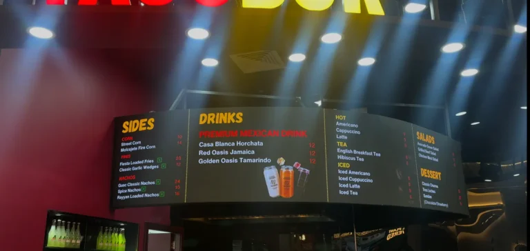 A restaurant with a flexible LED display menu board and bright lights.