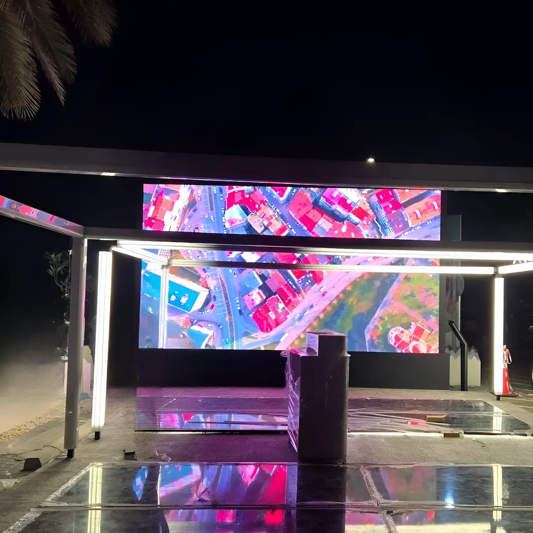 A large outdoor LED screen displaying a vibrant, colorful image in a public space.