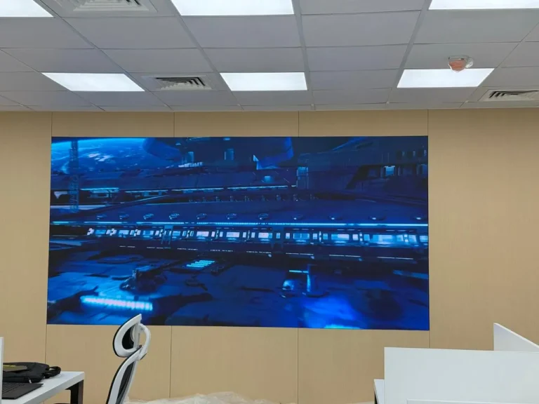 A large P1.53 SMD indoor screen mounted on the wall in a modern office setting
