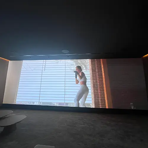 Built-in indoor LED wall screen showing a boxing workout video