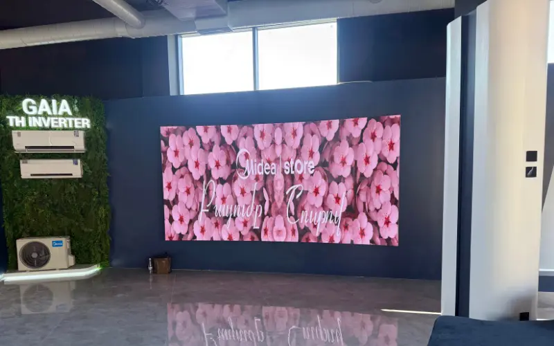 Indoor LED video wall displaying pink flowers in a Midea store