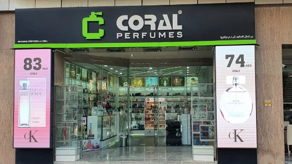 P4 LED screens on both sides of the Coral Perfumes storefront entrance, displaying perfume ads