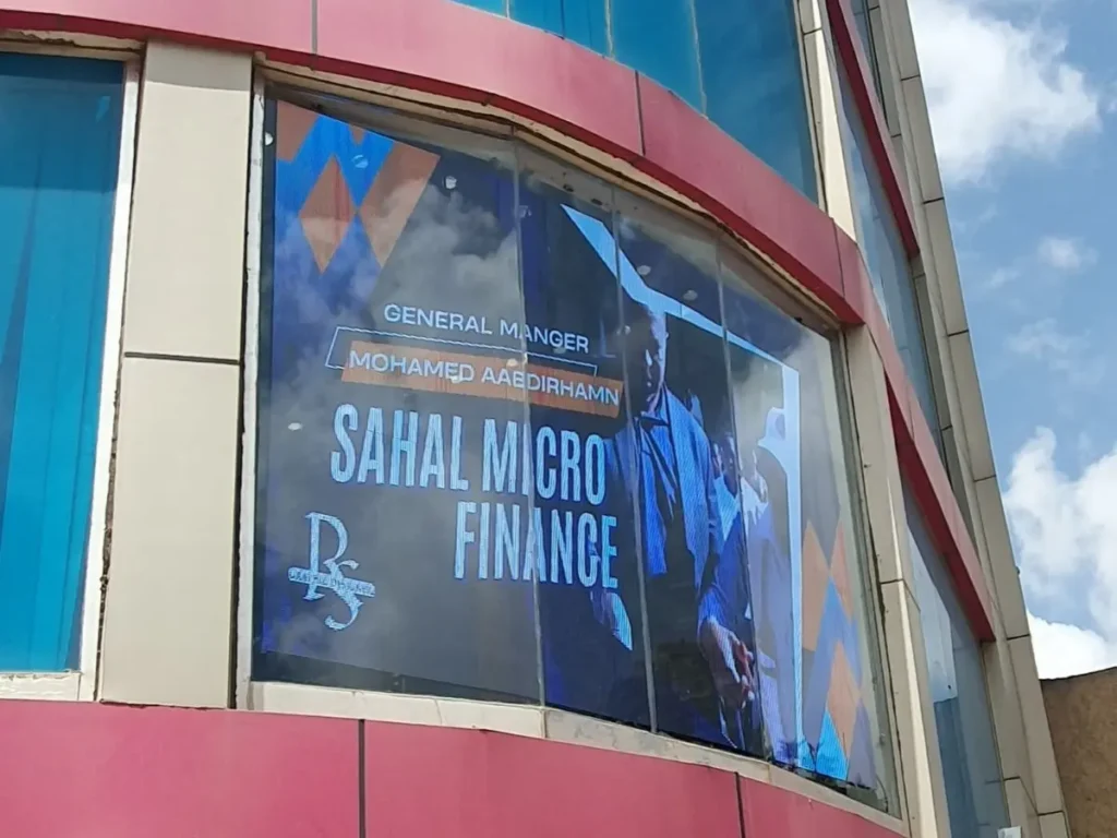Transparent LED display installed on a curved building window showing a advertisement