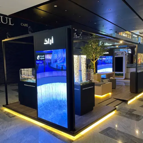 Vertical indoor LED screens in a real estate showcase booth inside a Dubai mall